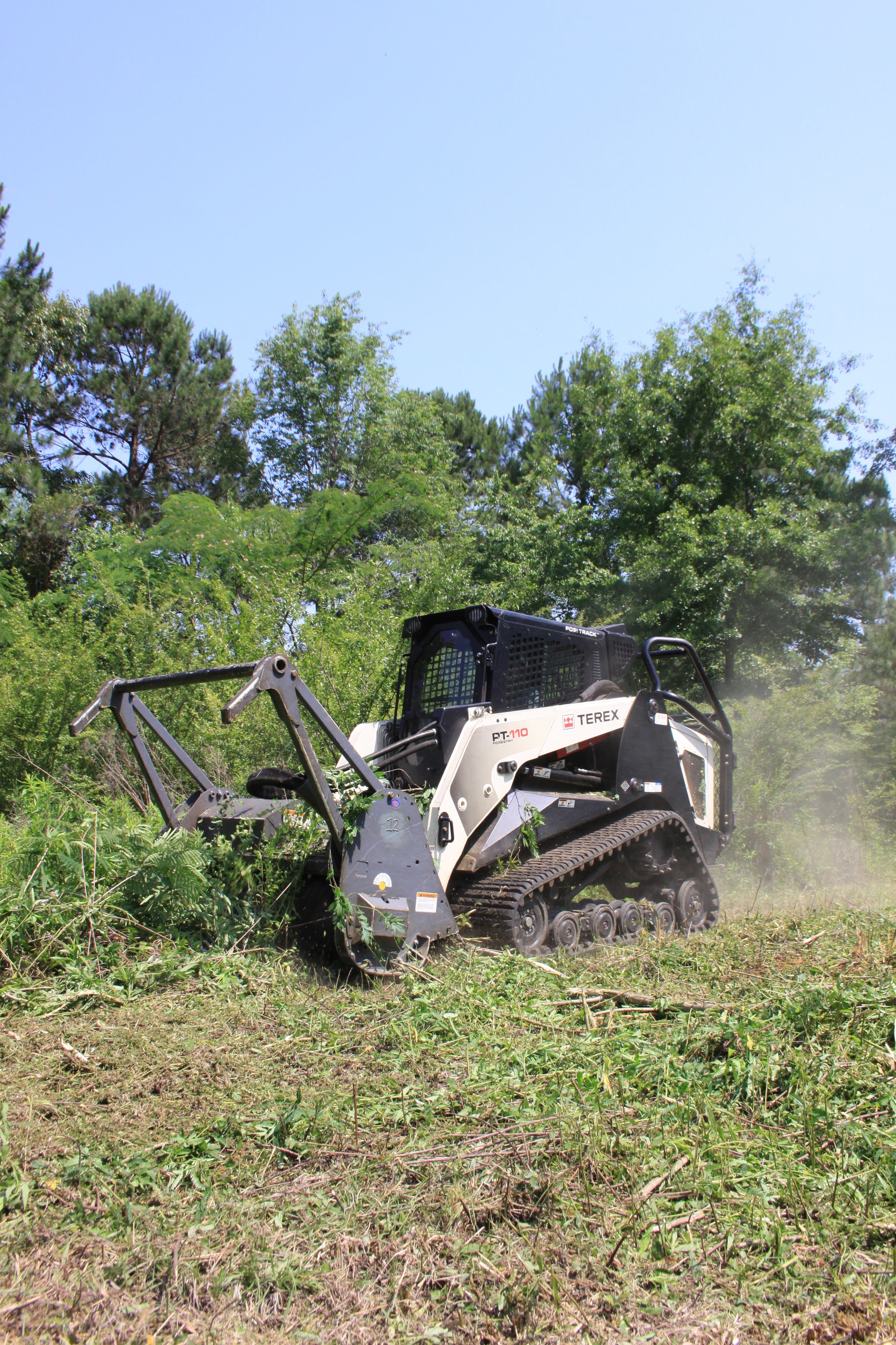 Skid Loader Land Clearing: Maneuvering with Precision